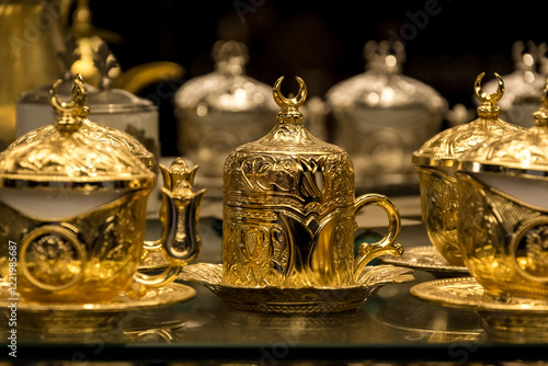 Canvas Print Traditional Arabic tea set with intricate golden designs and crescent moon finials