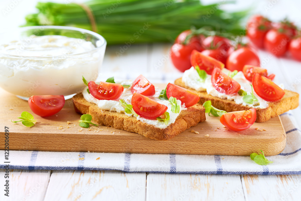 Sandwiches or toast with tomatoes cherry, cream cheese, olive oil and microgreen on a plate on white table. Sandwiches or toast with tomatoes cherry, cream cheese, olive oil and microgreen on a plate on white table.