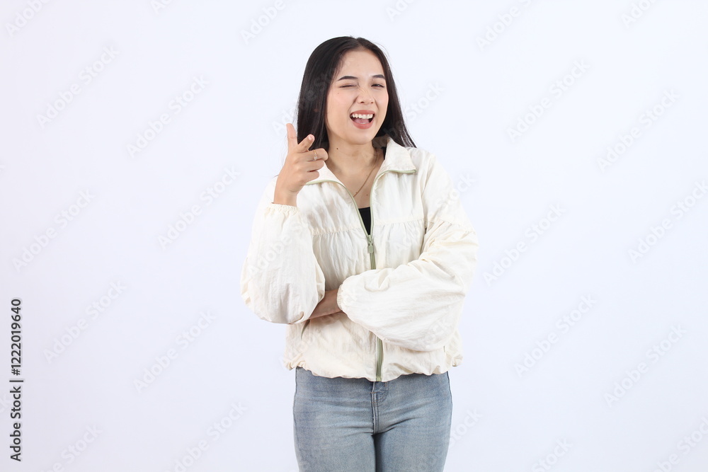 Woman Winks and Points Finger playfully while Smiling Cheerfully with arms Crossed Confidently on White Background. Woman Winks and Points Finger playfully while Smiling Cheerfully with arms Crossed Confidently on White Background.