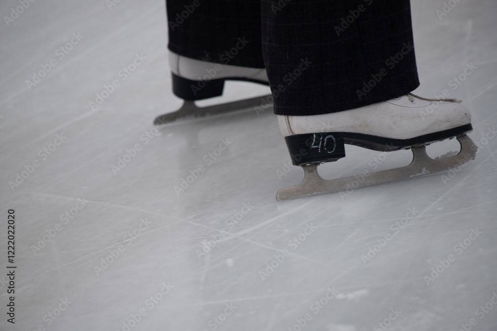 A person is skating on ice with the number 40 on their skates A person is skating on ice with the number 40 on their skates