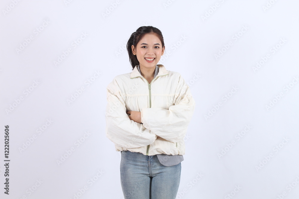 Woman Smiles and Crosses Arms Confidently on White Background with Positive Attitude Woman Smiles and Crosses Arms Confidently on White Background with Positive Attitude