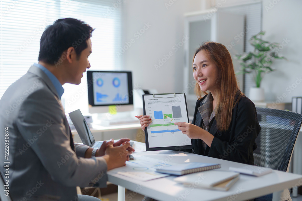 Asian businesspeople discussing marketing strategy during meeting in office Asian businesspeople discussing marketing strategy during meeting in office