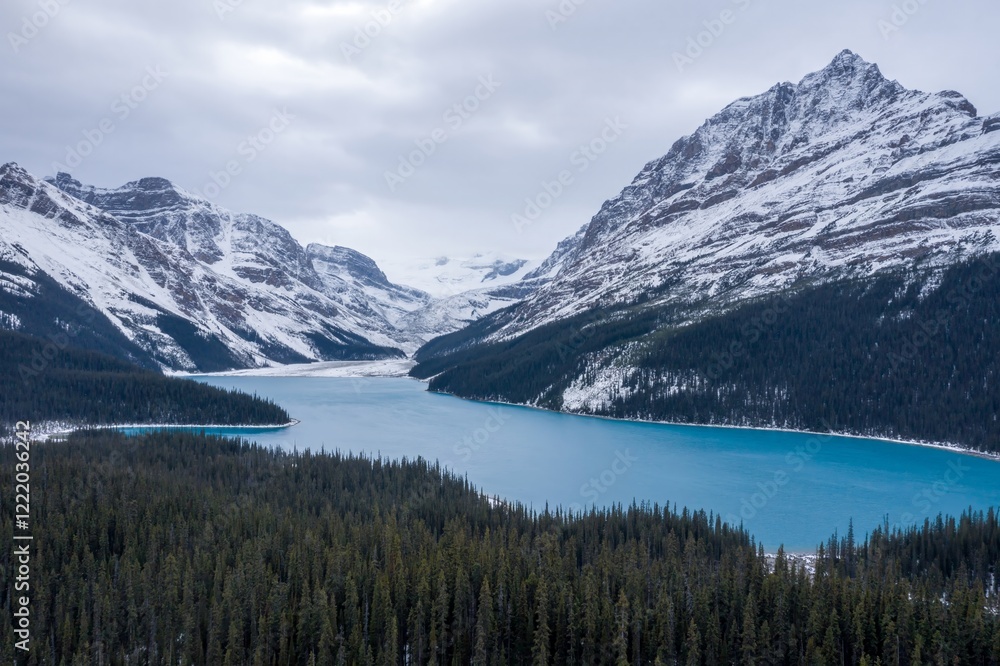 Stunning alpine lake nestled amongst snow-capped mountains. A vibrant turquoise lake surrounded by dense evergreen forests. Winter wonderland scenery. Peyto Lake, Banff National Park, Alberta, Canada Stunning alpine lake nestled amongst snow-capped mountains. A vibrant turquoise lake surrounded by dense evergreen forests. Winter wonderland scenery. Peyto Lake, Banff National Park, Alberta, Canada
