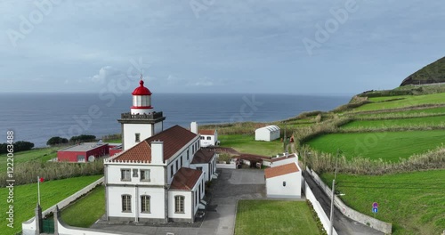 Drone footage of the Ferraria Lighthouse in Ginetes village in the Azores, Portgual photo