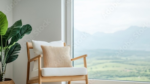 Indoor air quality minimalist idea. A cozy chair by a large window showcasing a serene mountain view. photo