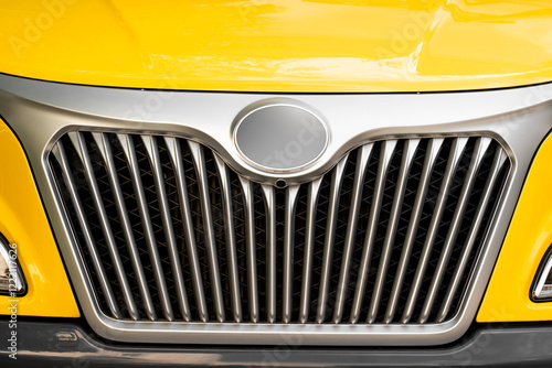 Close-up of the logo and chrome grille detail from a school bus. Child's view of a school bus. photo