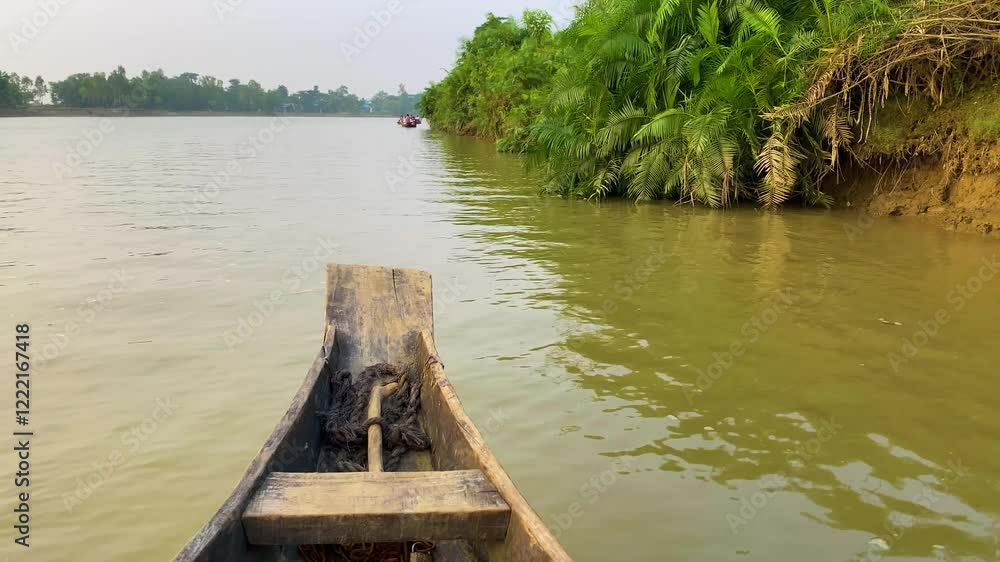 Wooden Boat Sailing Over Gowain River In Ratargul Swamp Forest In Sylhet, Bangladesh. POV Shot Wooden Boat Sailing Over Gowain River In Ratargul Swamp Forest In Sylhet, Bangladesh. POV Shot