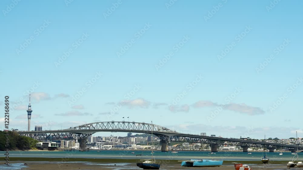 Harbor bridge and Auckland city skyline with yacht marina at low tide. Harbor bridge and Auckland city skyline with yacht marina at low tide.