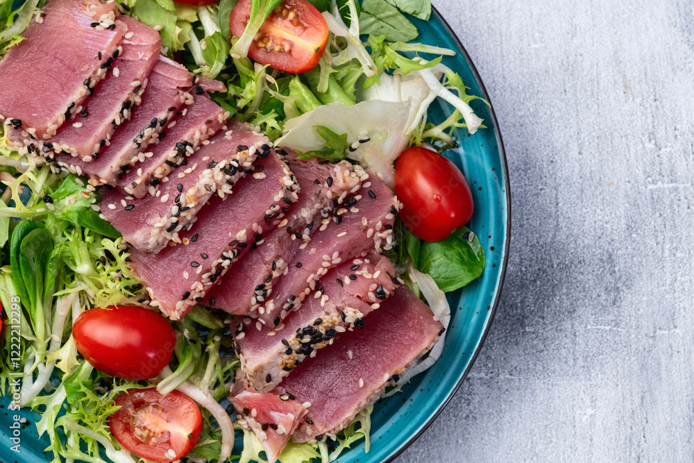 Salad with raw tuna , sesame and cherry tomatoes photography . Top view Salad with raw tuna , sesame and cherry tomatoes photography . Top view