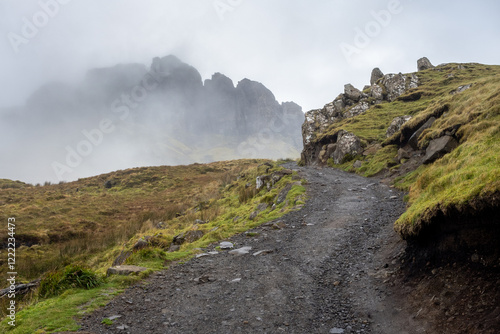 hiking path with a misty background to the Old Man of Storr on the Isle of Skye, Scotland, UK