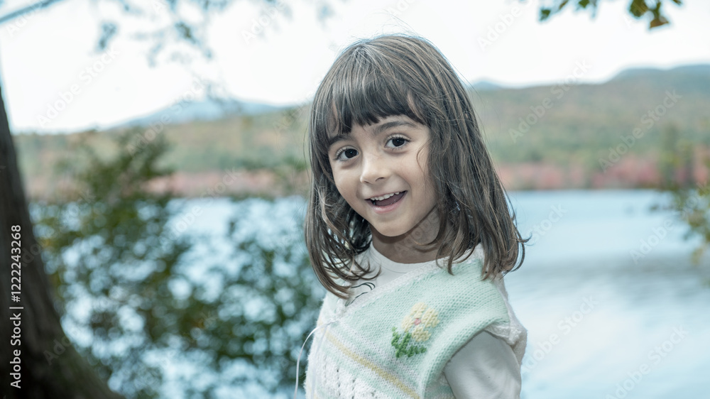 A happy young girl in the forest, autumn foliage season A happy young girl in the forest, autumn foliage season