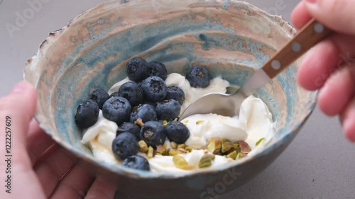 Greek yogurt with blueberries and pistachio bowl. Healthy breakfast concept.