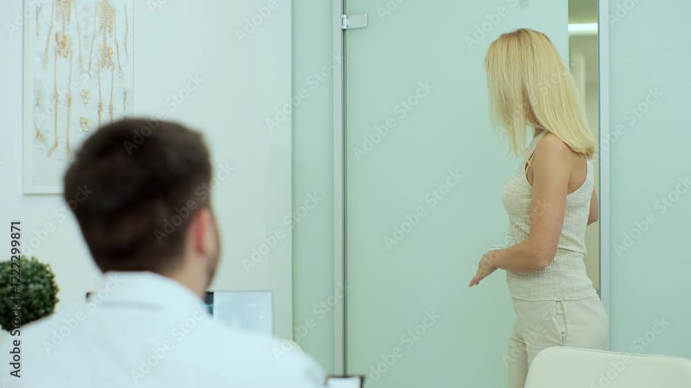 Portrait of caucasian middle-aged female patient entering hospital cabinet to man doctor. Physician giving advice to patient on consultation in clinic. Health concept. Portrait of caucasian middle-aged female patient entering hospital cabinet to man doctor. Physician giving advice to patient on consultation in clinic. Health concept.