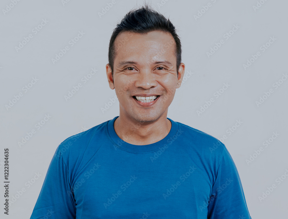 Closeup shot of young asian man wearing blue t-shirt isolated on white background.