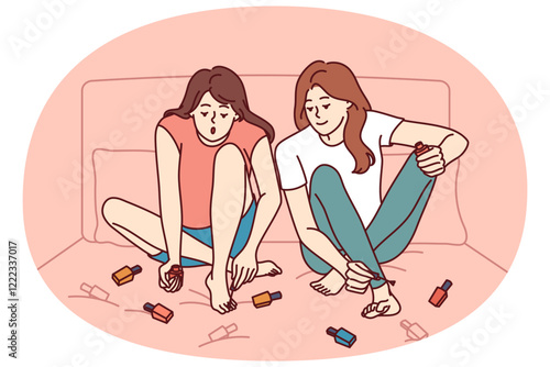 Two girls paint nails sitting on bed and doing pedicure before going to beach or party. Women friends paint toenails with varnish of different colors, wanting to be beautiful and elegant.
