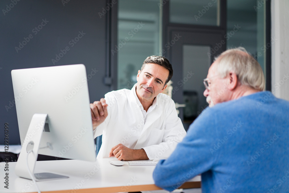 Doctor sharing computer screen with patient in medical practice Doctor sharing computer screen with patient in medical practice