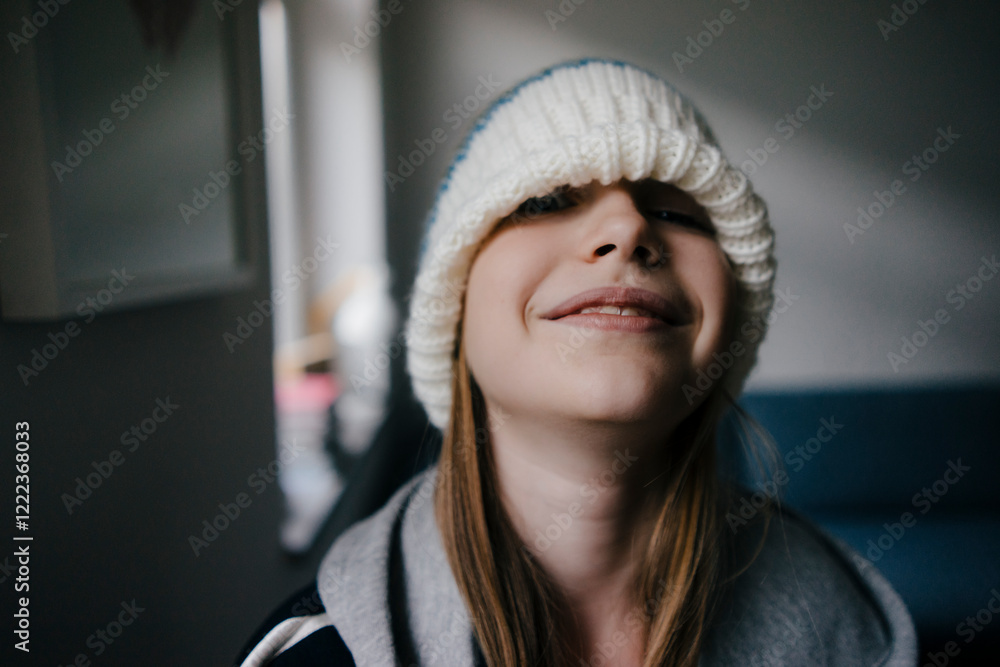 Portrait of girl wearing wooly hat at home Portrait of girl wearing wooly hat at home