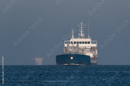 MARITIME TRANSPORT - Blue ship on the waterway photo