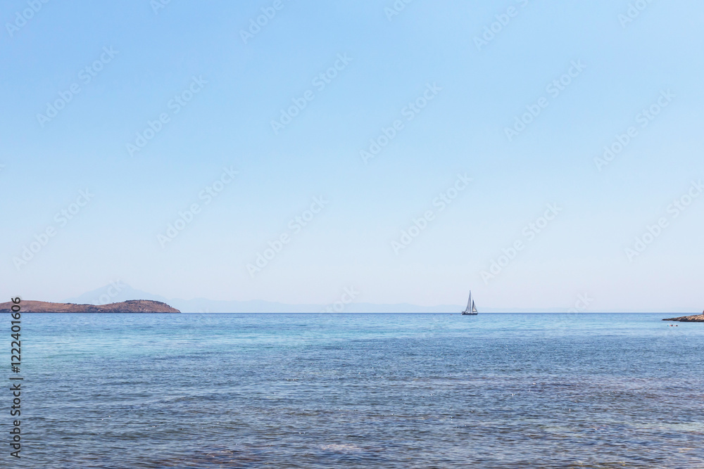 A tranquil scene of a sailboat gliding across the crystal-clear waters of the Aegean Sea, with a small island in the distance A tranquil scene of a sailboat gliding across the crystal-clear waters of the Aegean Sea, with a small island in the distance