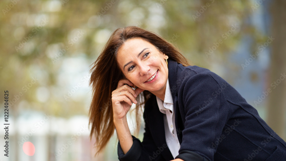 candid portrait woman tilting her head slightly, with her hand resting near her ear. candid portrait woman tilting her head slightly, with her hand resting near her ear.
