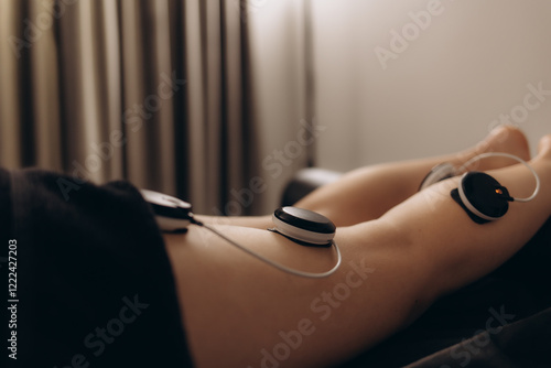 Obraz na plátně Physiotherapist applying electro stimulation in physical therapy to a young woman