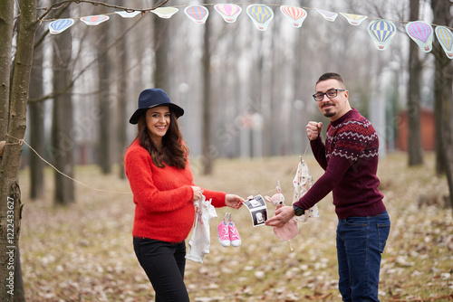 Couple announcing pregnancy outdoors photo