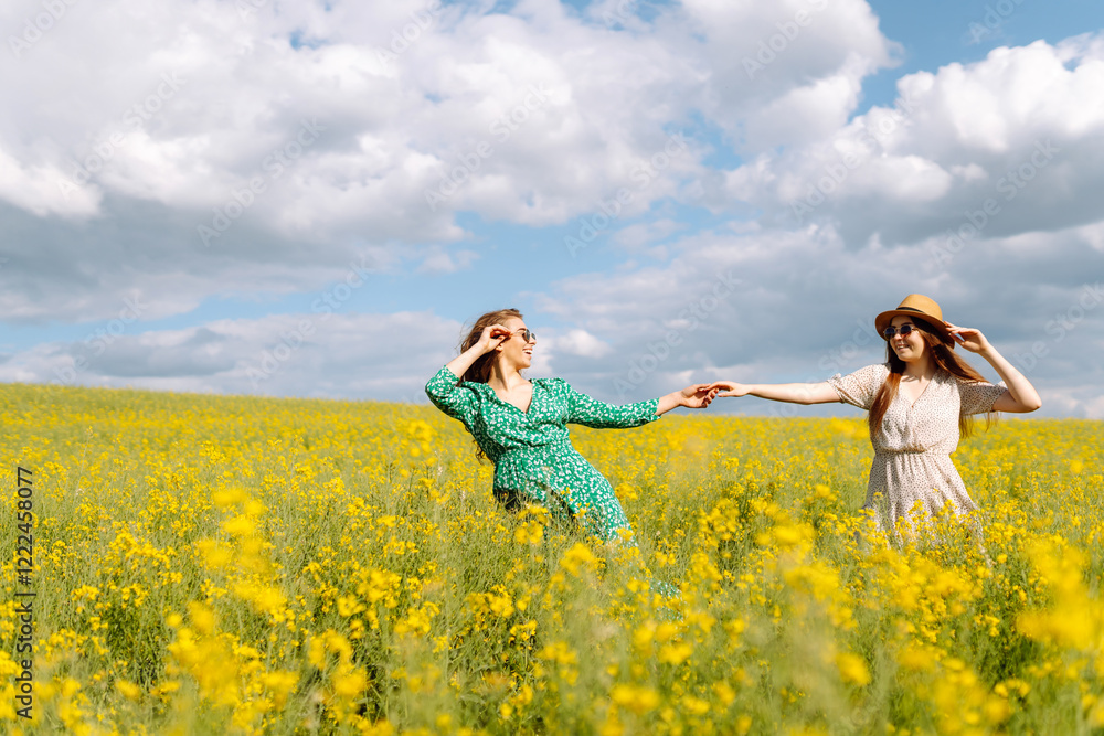 Two Beautiful women enjoying nature on the field. Nature, vacation, relax and lifestyle. Summer landscape. Two Beautiful women enjoying nature on the field. Nature, vacation, relax and lifestyle. Summer landscape.
