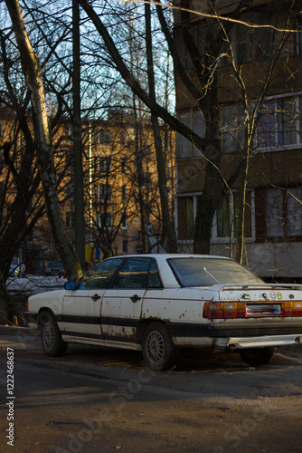 Old white car in the yard