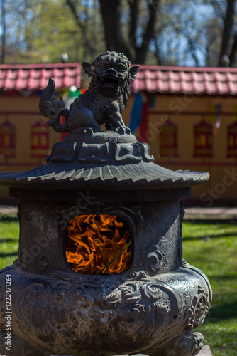 Statue of a lion with fire in the Buddhist temple Datsan Gunzechoinei photo