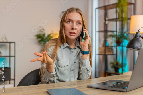 Obraz na plátne Nervous angry female manager quarrelling smartphone call online at home office desk