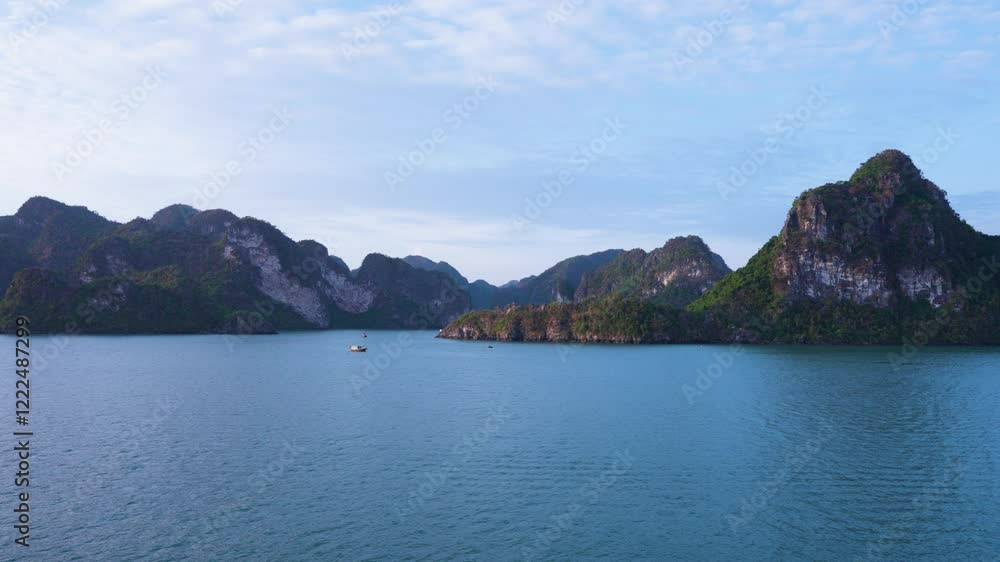 A mesmerizing aerial view of Ha Long Bay's emerald waters embracing limestone karsts and islets that rise dramatically from the sea, creating a mystical seascape with a lone boat A mesmerizing aerial view of Ha Long Bay's emerald waters embracing limestone karsts and islets that rise dramatically from the sea, creating a mystical seascape with a lone boat