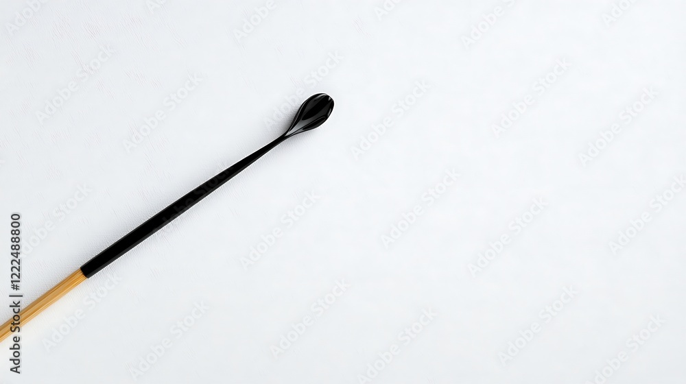 Black Handled Wooden Spoon on White Background Black Handled Wooden Spoon on White Background