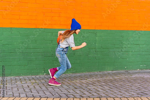 Young girl running with basketball