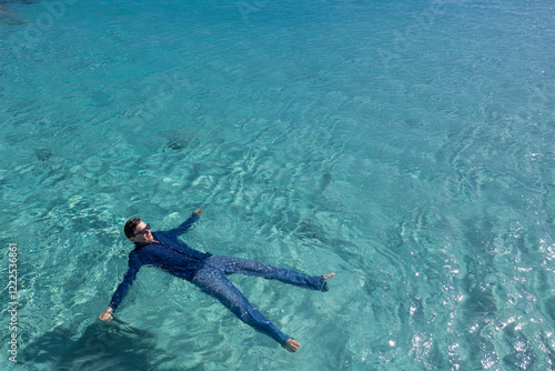 Man swimming in water at ocean photo