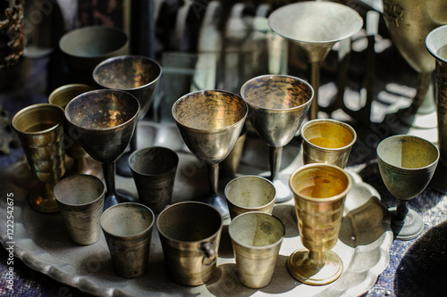 Collection of antique, metal silver kiddush cups traditionally used for reciting the Jewish blessing over wine. photo