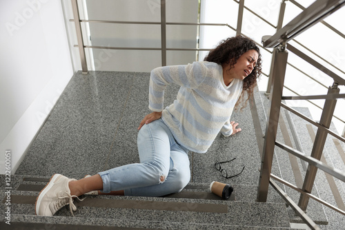Slika na platnu Woman with injured back on stairs in building after fall