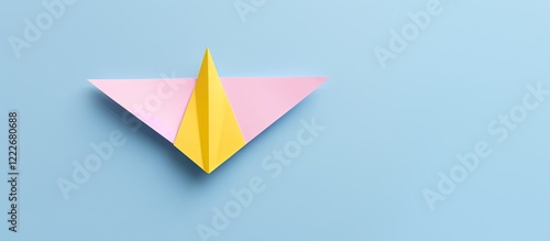Free Download Colorful yellow paper airplane positioned centrally against a pastel pink and blue background in a minimal flat lay design ideal for school concepts - GFXLoad