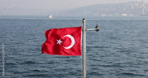 Captivating slow motion view of the Turkish flag on a ship cruising the Istanbul Bosphorus. Cinematic and high quality city silhouette.