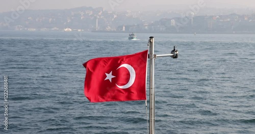 Captivating slow motion view of the Turkish flag on a ship cruising the Istanbul Bosphorus. Cinematic and high quality city silhouette.