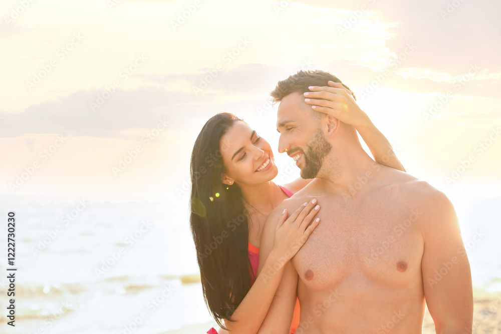 Happy young couple on beach on sunny day Happy young couple on beach on sunny day