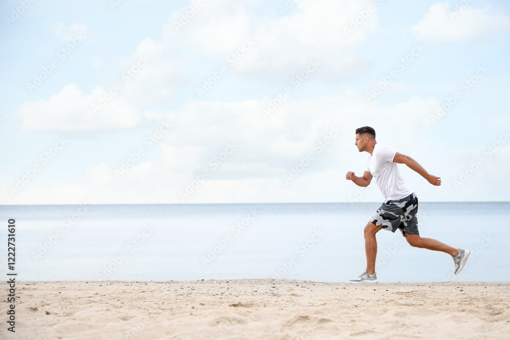 Muscular man running on beach, space for text. Body training Muscular man running on beach, space for text. Body training