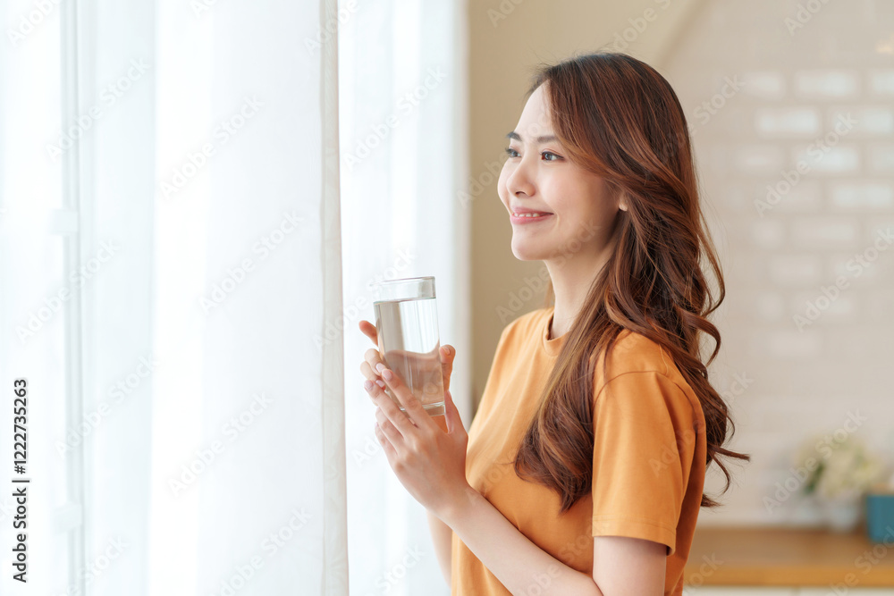 portrait smiling young woman with a glass of fresh water relaxing in the room,people with healthy lifestyle,health,beauty,health care portrait smiling young woman with a glass of fresh water relaxing in the room,people with healthy lifestyle,health,beauty,health care