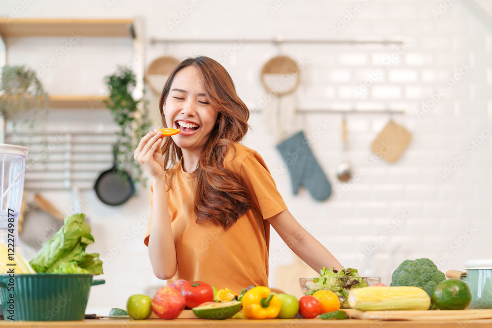 portrait cheerful young woman having fun,cooking in the kitchen hand holding piece of orange slice to eat,healthy food,nutrition,vitamin,beauty,health portrait cheerful young woman having fun,cooking in the kitchen hand holding piece of orange slice to eat,healthy food,nutrition,vitamin,beauty,health
