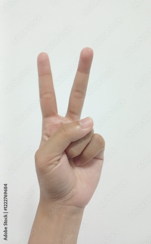 Close up Asian female hand in scissors gesture, number two, victorious gesture, sign finger arm and hand isolated on a white background copy space symbol Close up Asian female hand in scissors gesture, number two, victorious gesture, sign finger arm and hand isolated on a white background copy space symbol