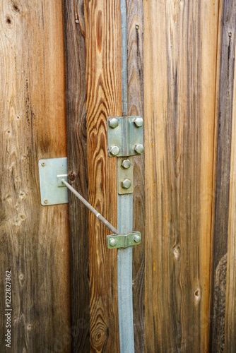 External elements of the lightning protection system on the wall of a wooden building - Place of connection of the discharge cable to the grounding system
