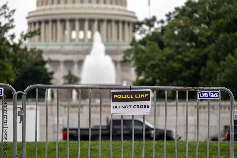 Police barricades with a view of the Capitol dome in the background, showcasing public safety and restricted access. Photo taken in Washington DC, USA.