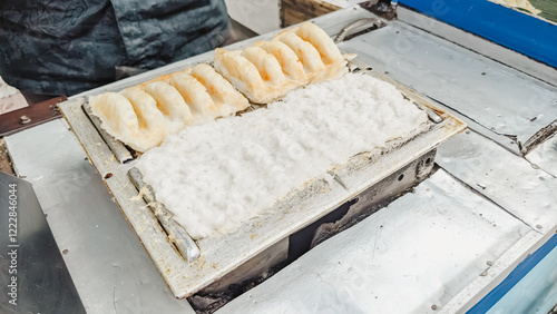 High angle view. The serving process of an authentic Indonesian traditional cake  famously known as Bandros or Gandos. Best served with crystal sugar photo