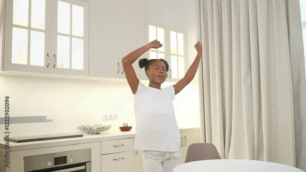 young black lady dancing in kitchen young black lady dancing in kitchen