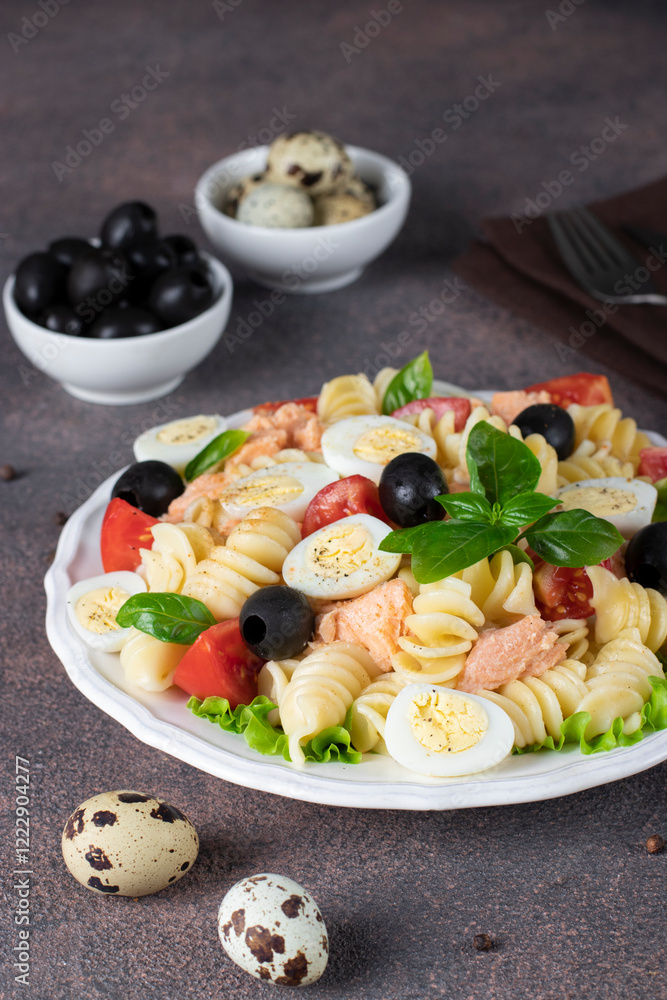 Canned salmon salad with pasta, cherry tomatoes, quail eggs, basil and black olives Canned salmon salad with pasta, cherry tomatoes, quail eggs, basil and black olives