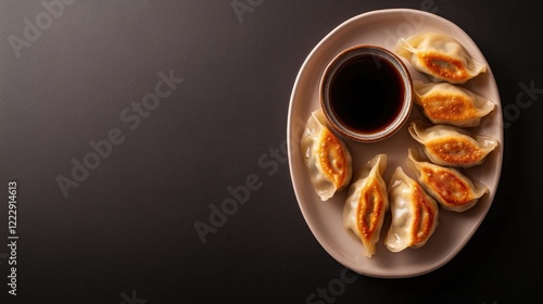 Delicious dumplings arranged on plate with dipping sauce, showca